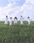 Diverse Women Running Down a green hill in white clothing